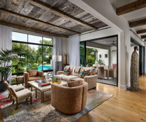 The living area of a modern home with large windows.