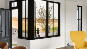Interior view of an open casement window by the front door of a modern-looking home